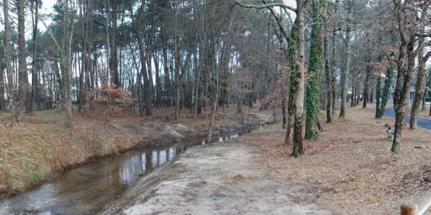 Les bords préservés du ruisseau permettent d'accueillir une piste cyclable à proximité de l'entrée de ville de Gujan-Mestras, visible à droite. 